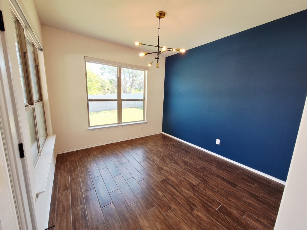 1104 River Vista Road Georgetown, TX 78628 - Photo 21 of 39 a view of an empty room with wooden floor and a window