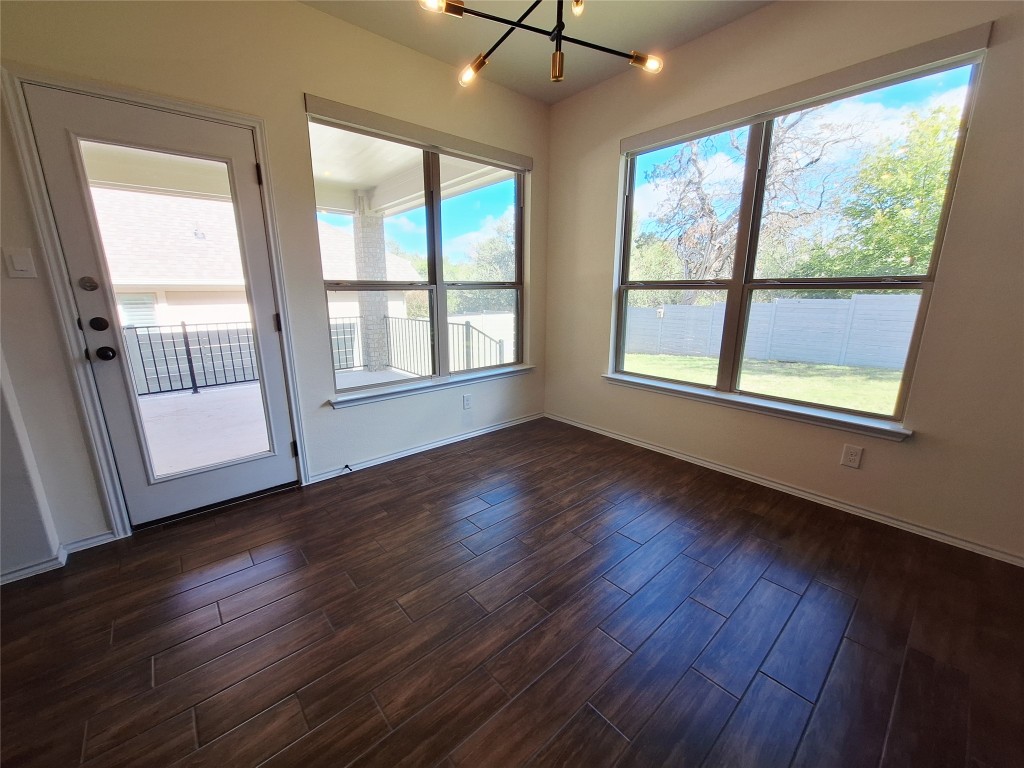 1104 River Vista Road Georgetown, TX 78628 - Photo 22 of 39 a view of an empty room with wooden floor and a window