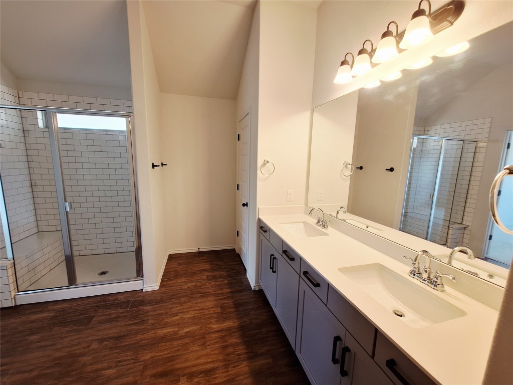 1104 River Vista Road Georgetown, TX 78628 - Photo 25 of 39 a bathroom with a double vanity sink mirror and shower