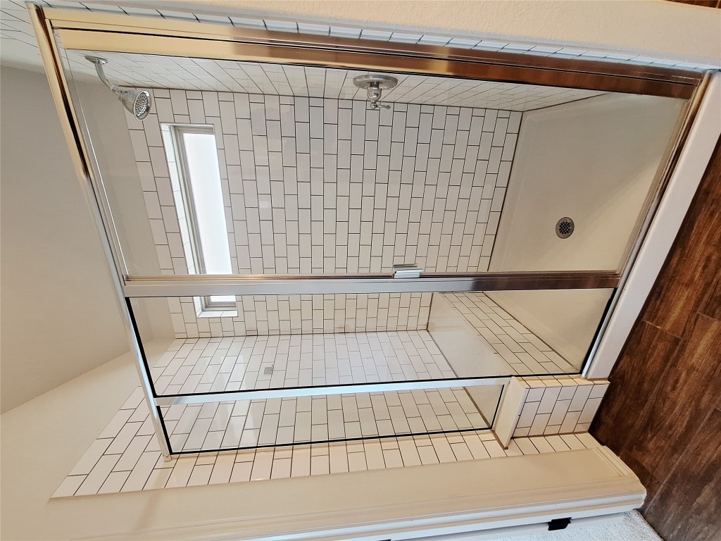 1104 River Vista Road Georgetown, TX 78628 - Photo 26 of 39 a bathroom with a glass shower door