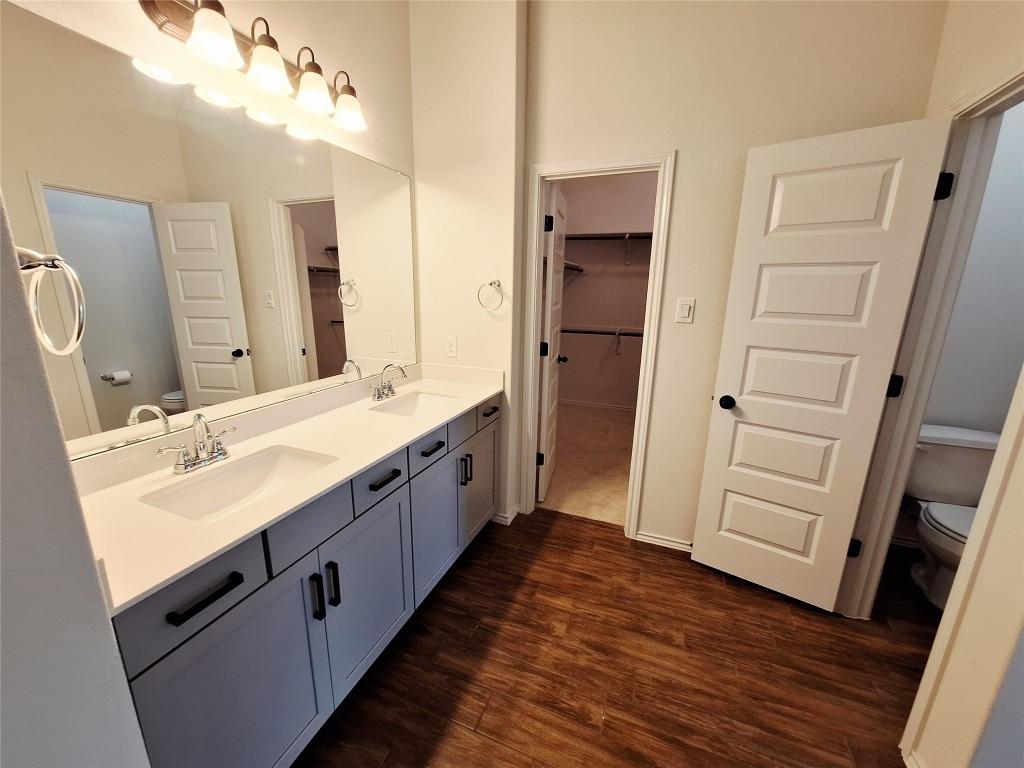 1104 River Vista Road Georgetown, TX 78628 - Photo 27 of 39 a spacious bathroom with a double vanity sink and a mirror