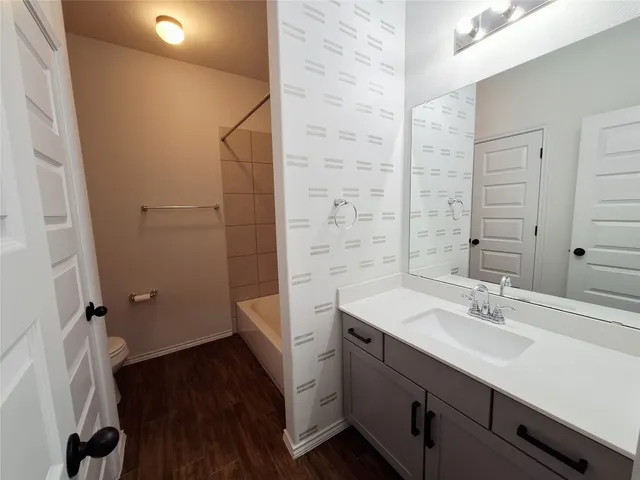 a bathroom with a sink a mirror and a toilet