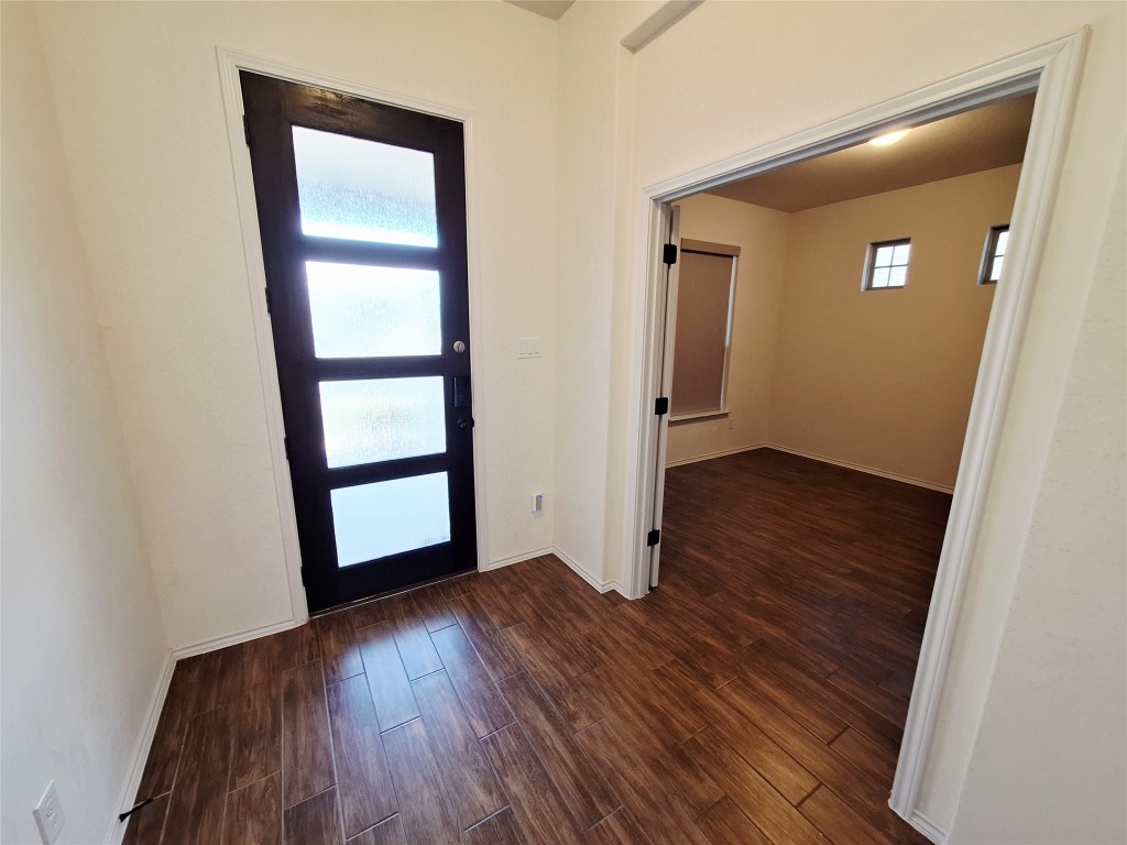 1104 River Vista Road Georgetown, TX 78628 - Photo 5 of 39 an empty room with wooden floor and closet
