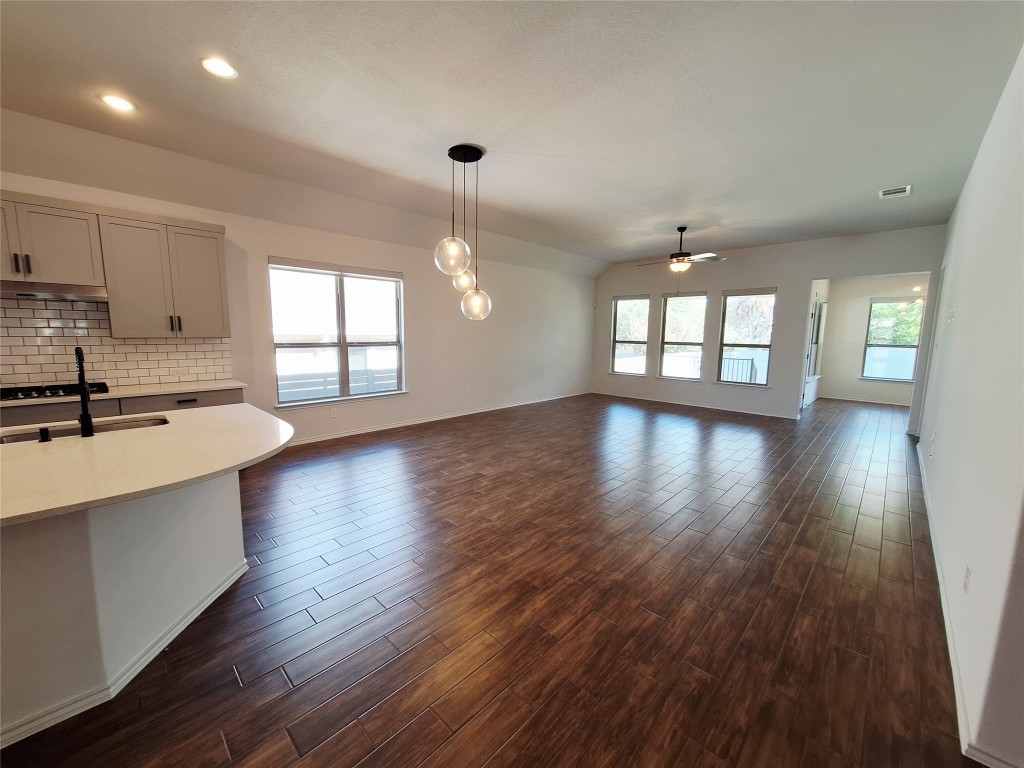 1104 River Vista Road Georgetown, TX 78628 - Photo 8 of 39 a view of an empty room with wooden floor and a window