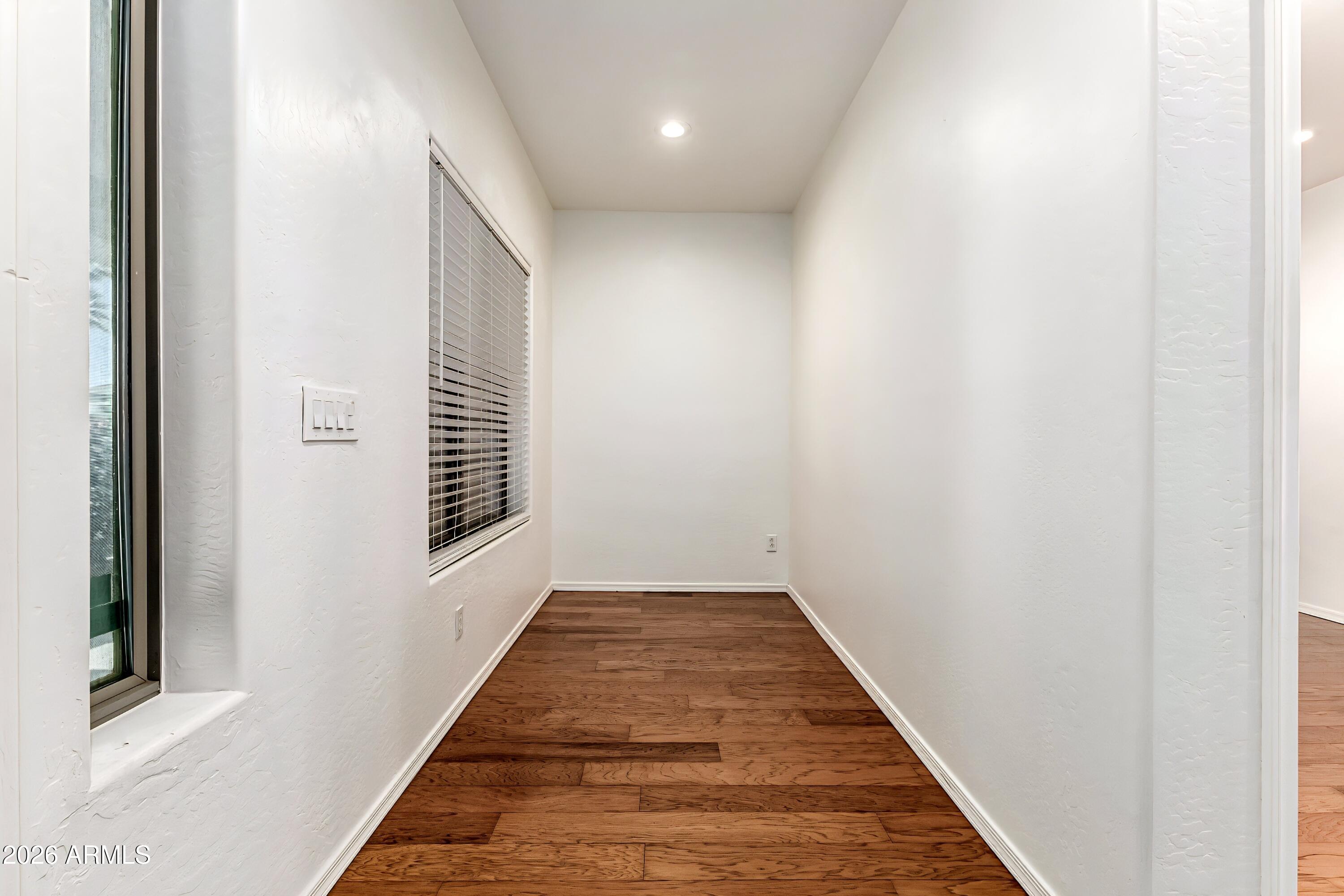 4208 South Sawmill Road Gilbert, AZ 85297 - Photo 6 of 46 a view of a hallway with wooden floor