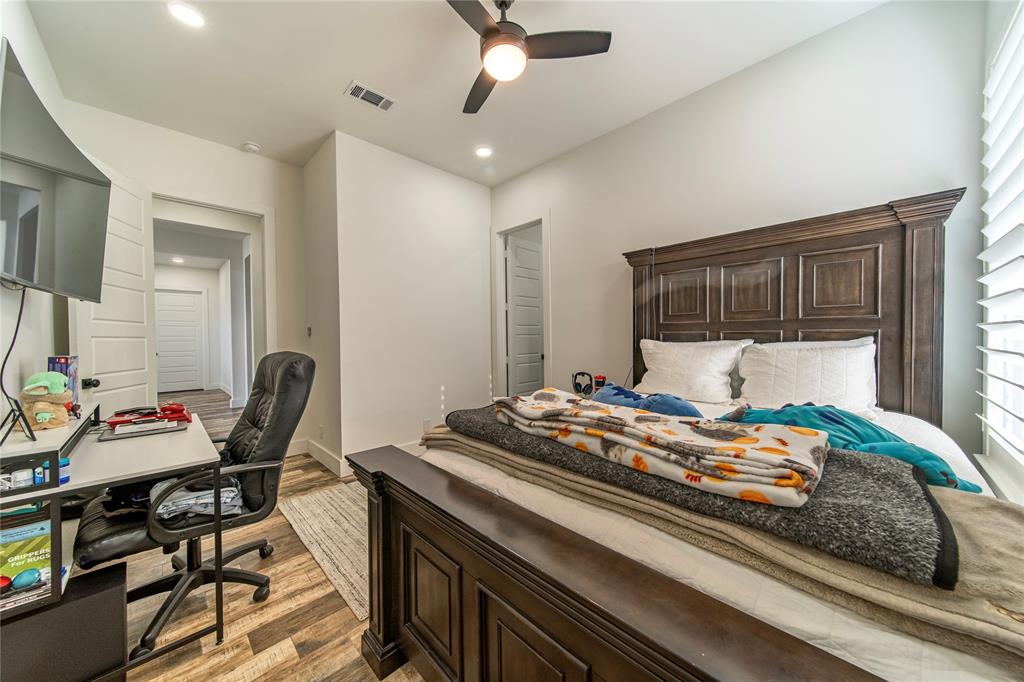 165 Ranch House Road Rockwall, TX 75032 - Photo 23 of 40 a bedroom with a bed and wooden floor