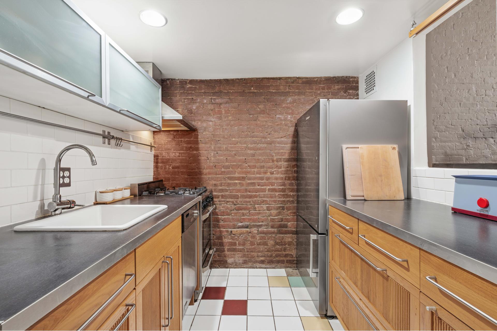 455 West 43rd Street, Unit 5A Manhattan, NY 10036 - Photo 6 of 8 a bathroom with a sink a vanity and a mirror