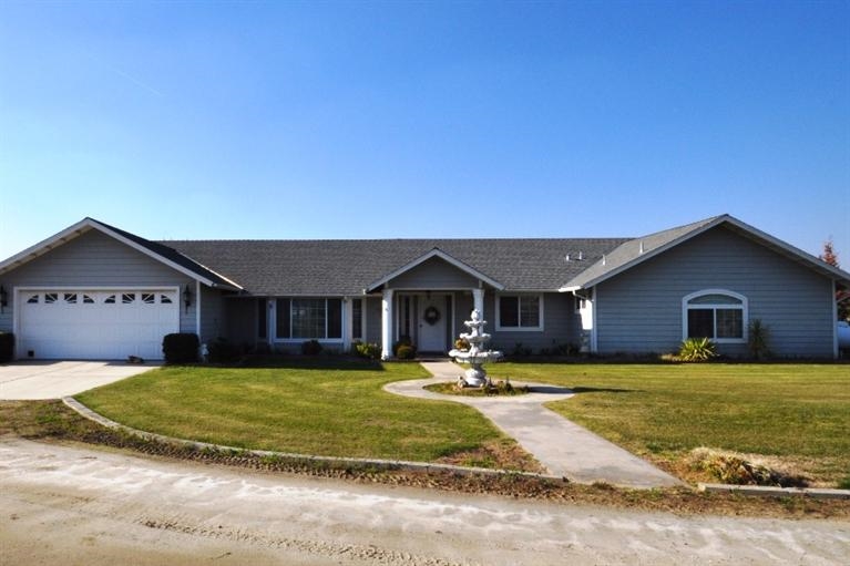20344 Thermal Road Sanger, CA 93657 - Photo 1 of 10 a view of a house with a big yard and large trees