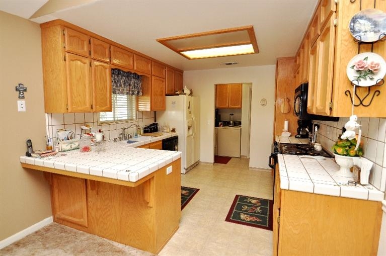 20344 Thermal Road Sanger, CA 93657 - Photo 8 of 10 a kitchen with a sink a stove and a refrigerator