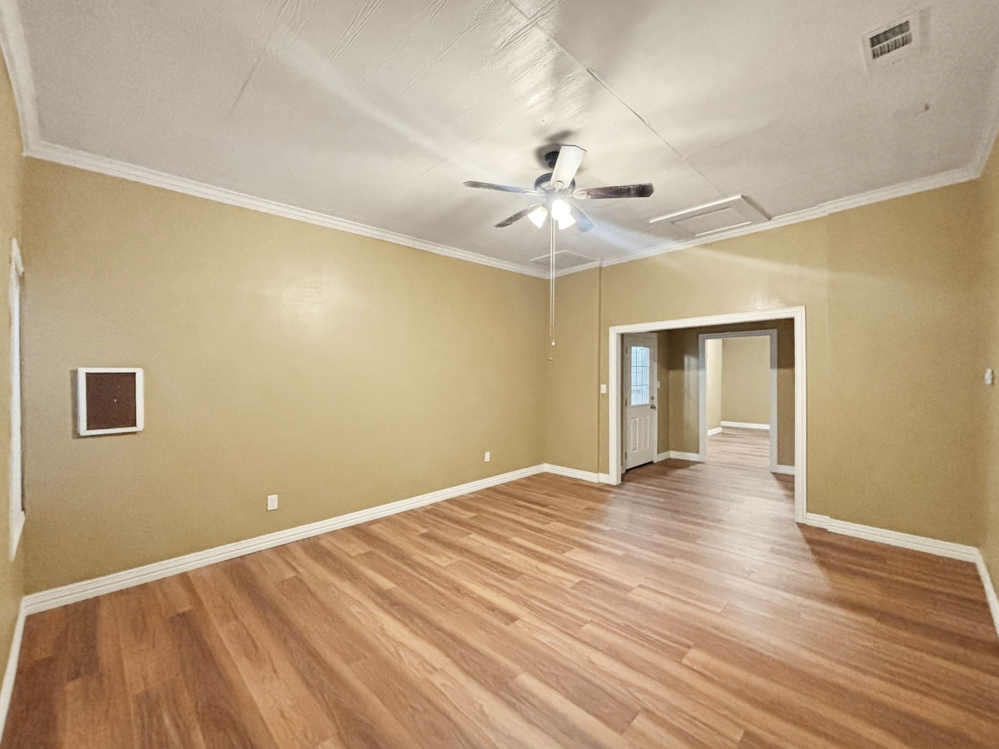 144 Wood Farm Road Huntsville, TX 77320 - Photo 14 of 50 a view of an empty room with wooden floor and a ceiling fan