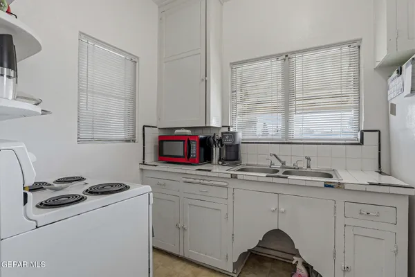a bedroom with a bed and a large mirror