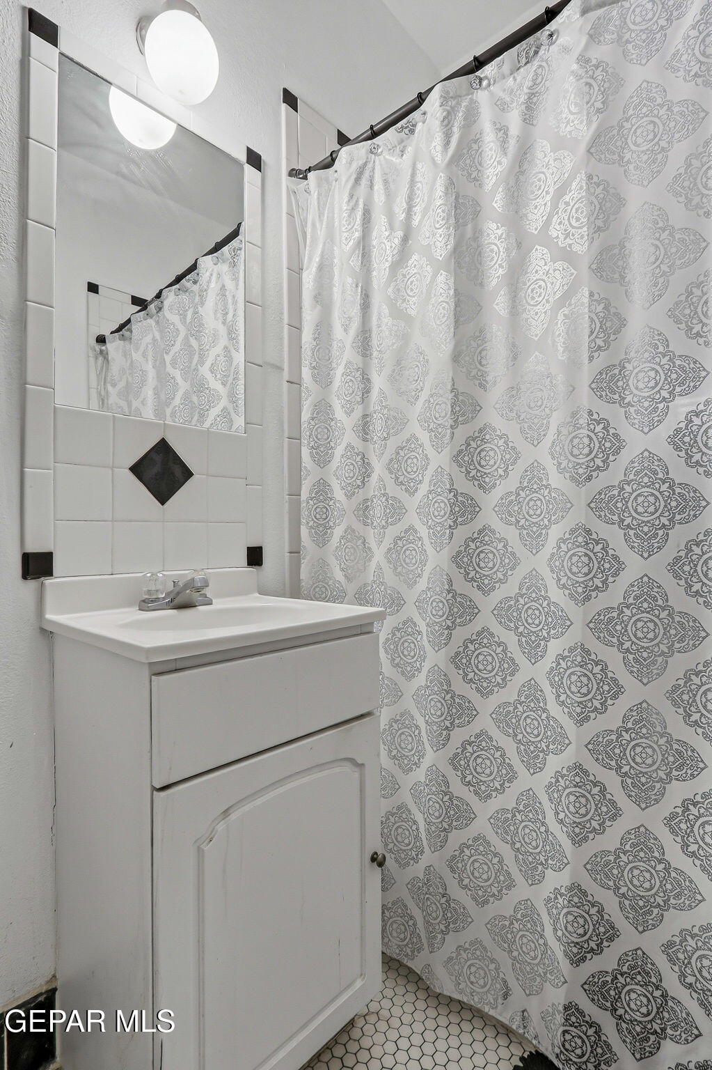 4333 Pershing Drive El Paso, TX 79903 - Photo 42 of 75 a bathroom with a sink and mirror