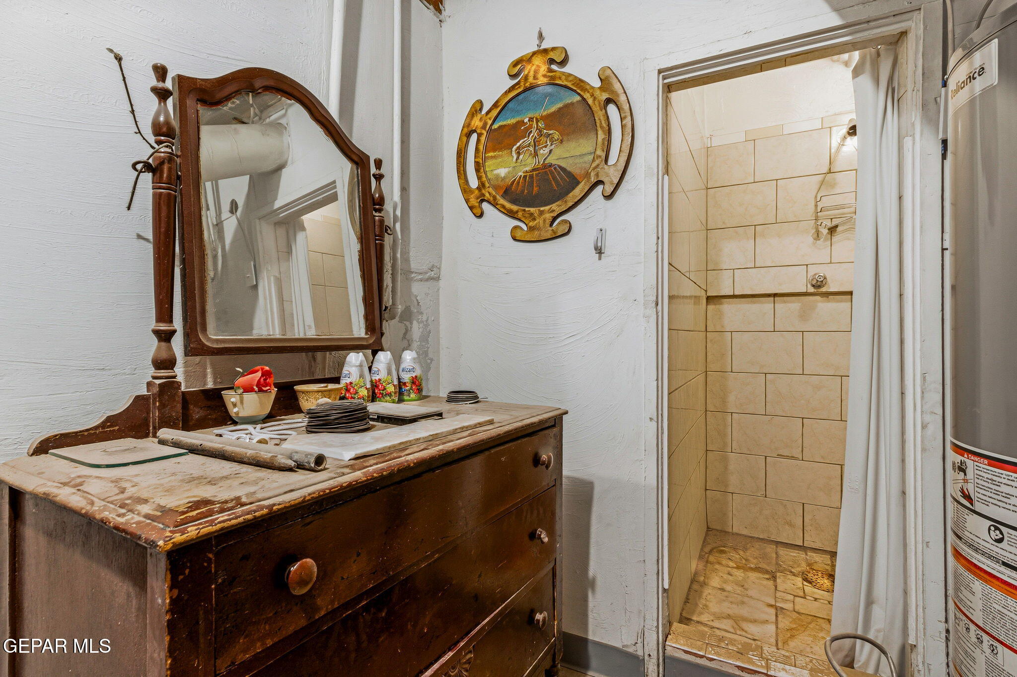 4333 Pershing Drive El Paso, TX 79903 - Photo 60 of 75 a bathroom with a granite countertop sink and a mirror