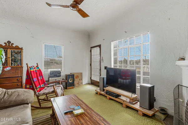 a living room with furniture a flat screen tv and a fireplace