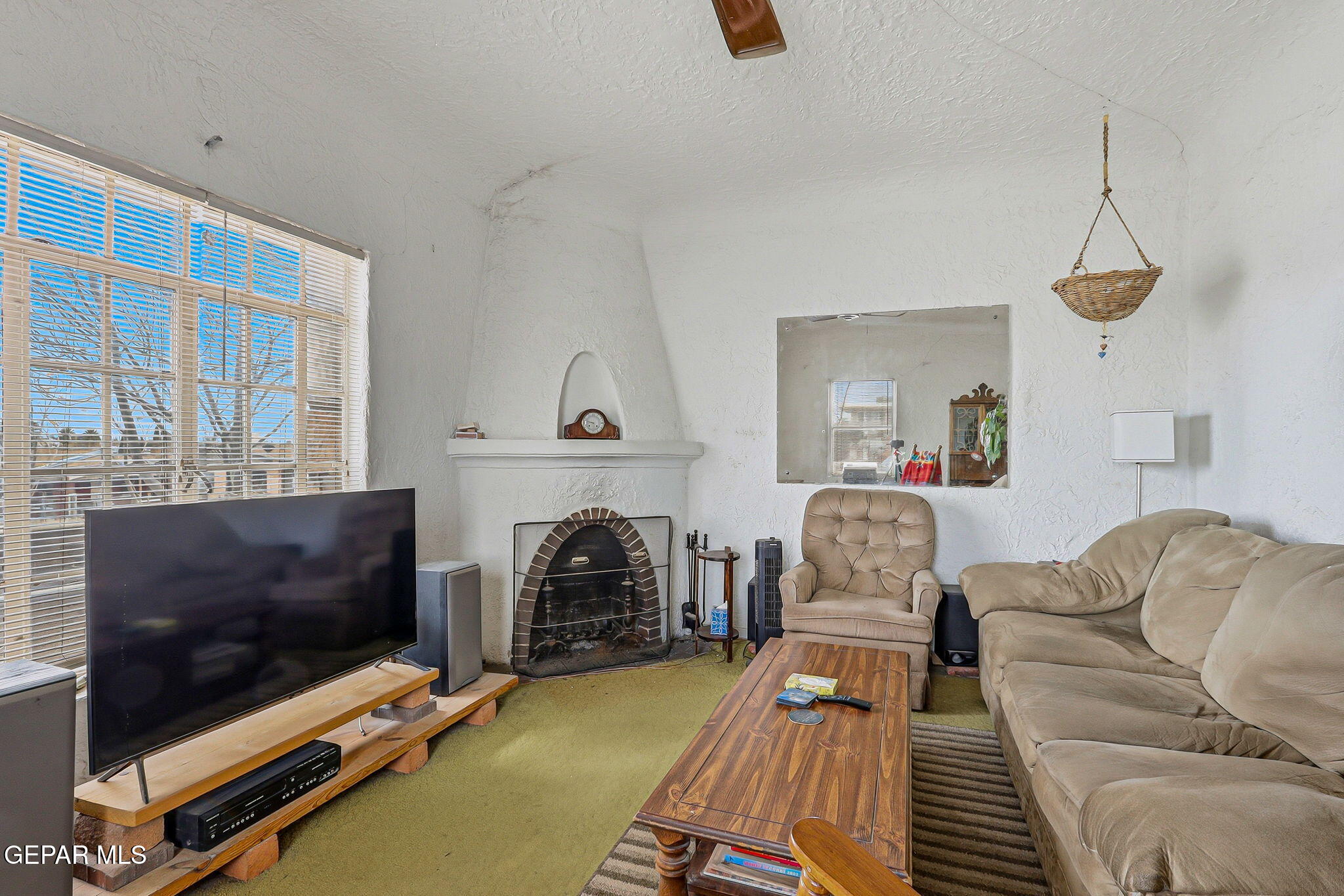 4333 Pershing Drive El Paso, TX 79903 - Photo 7 of 75 a living room with furniture a flat screen tv and a fireplace