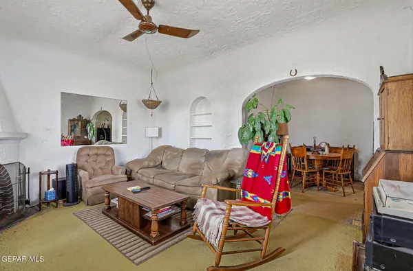 a living room with furniture a flat screen tv and a window