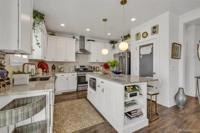 a kitchen with a sink stove and cabinets