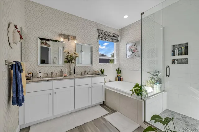 a bathroom with a tub sink and mirror