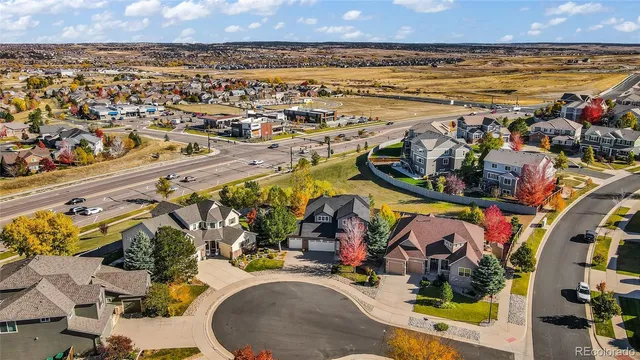 an aerial view of a house with a yard and garden