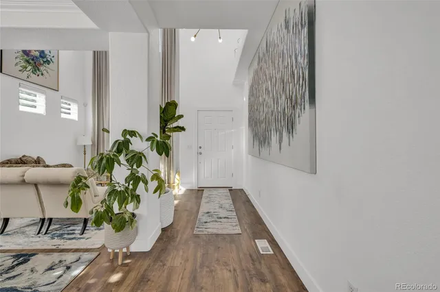 a view of a hallway with wooden floor