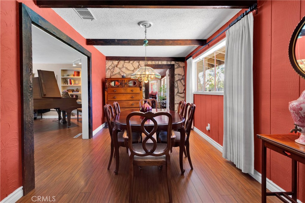 19955 Chickasaw Road Apple Valley, CA 92307 - Photo 13 of 60 a view of a dining room with furniture window and wooden floor