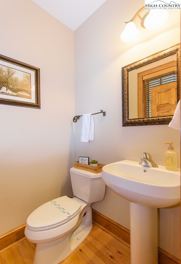 145 Rising Fawn Pass, Unit 17B Boone, NC 28607 - Photo 15 of 49 a bathroom with a sink a toilet and mirror