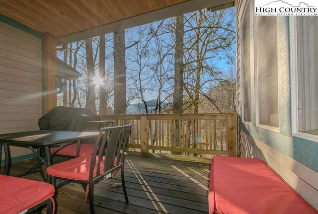 a view of a balcony with chairs and wooden floor