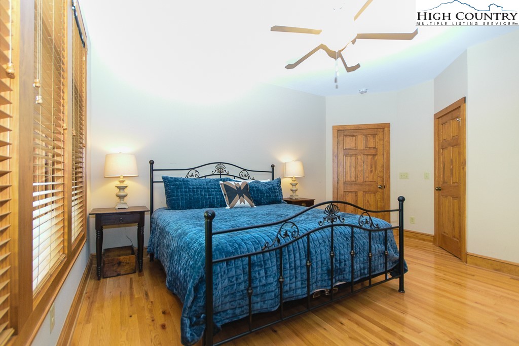 145 Rising Fawn Pass, Unit 17B Boone, NC 28607 - Photo 19 of 49 a bedroom with a bed and wooden floor