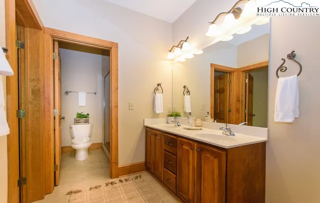 a bathroom with a double vanity sink and a mirror