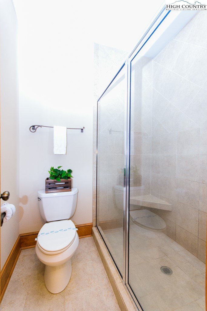 145 Rising Fawn Pass, Unit 17B Boone, NC 28607 - Photo 22 of 49 a bathroom with a toilet and a shower