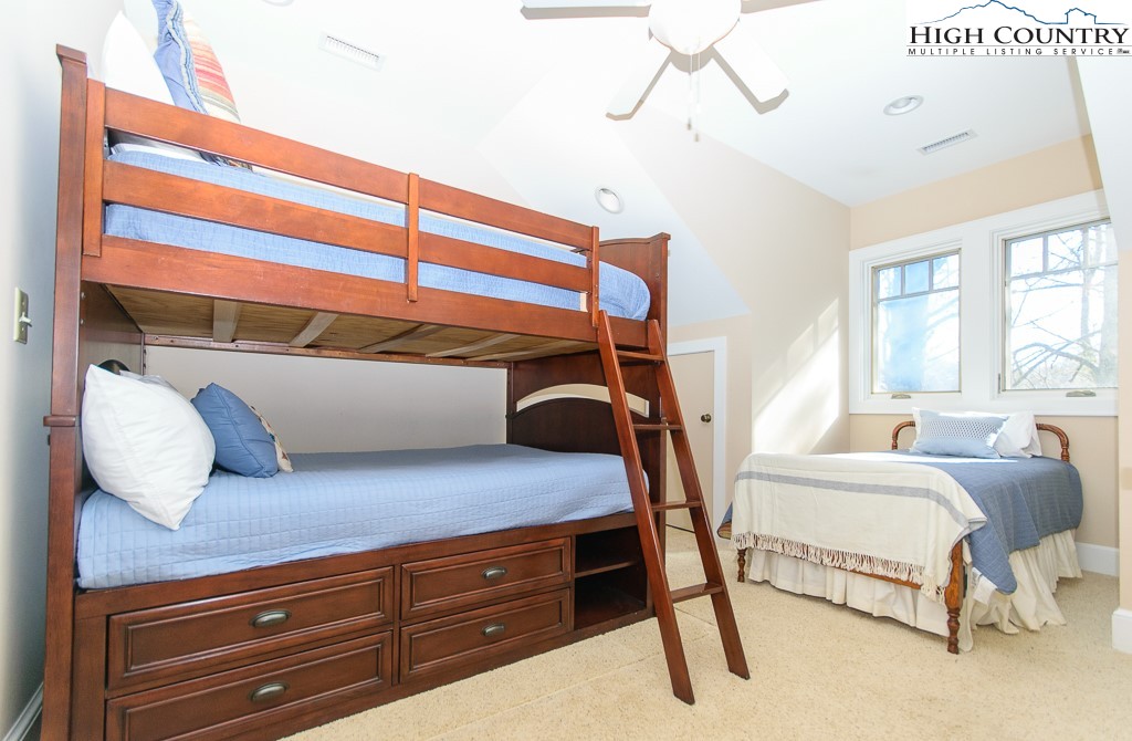145 Rising Fawn Pass, Unit 17B Boone, NC 28607 - Photo 24 of 49 a bedroom with a bed and window