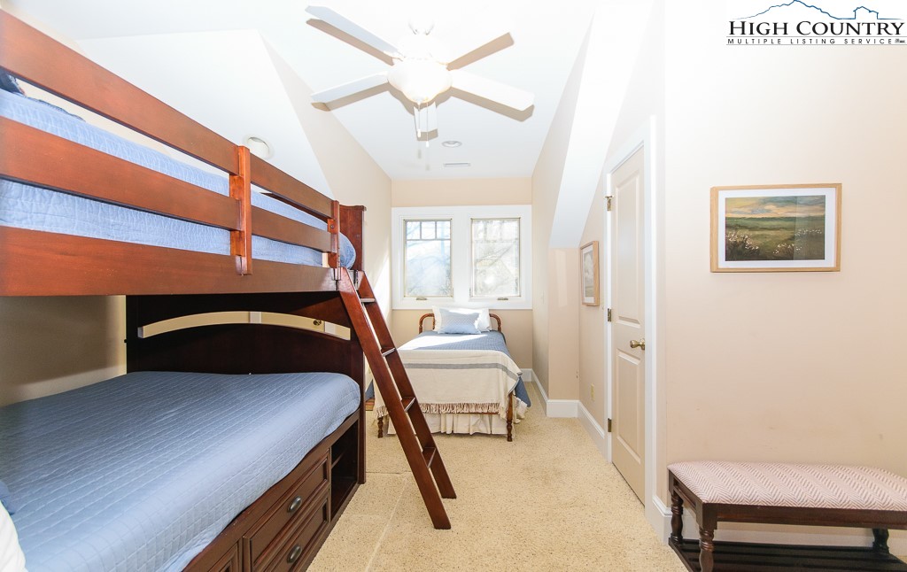 145 Rising Fawn Pass, Unit 17B Boone, NC 28607 - Photo 25 of 49 a bedroom with a bed and a chair