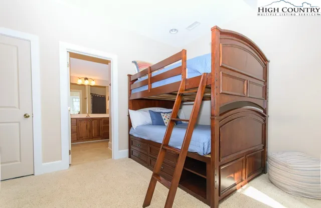 a bathroom with a granite countertop sink mirror vanity and toilet