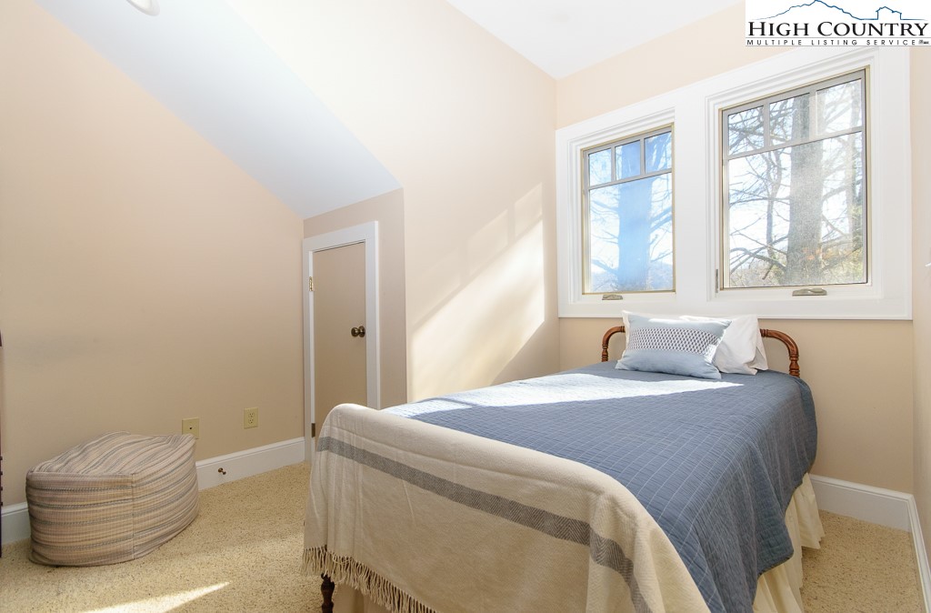 145 Rising Fawn Pass, Unit 17B Boone, NC 28607 - Photo 27 of 49 a bedroom with a bed and a window