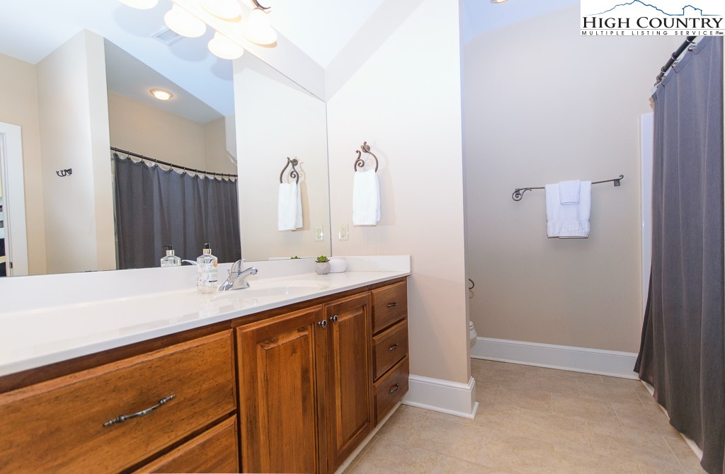 145 Rising Fawn Pass, Unit 17B Boone, NC 28607 - Photo 28 of 49 a bathroom with a sink vanity and mirror