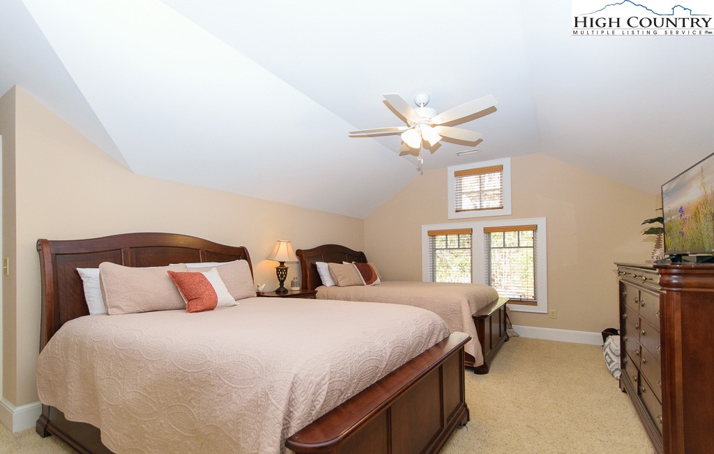 145 Rising Fawn Pass, Unit 17B Boone, NC 28607 - Photo 30 of 49 a bedroom with a bed and window