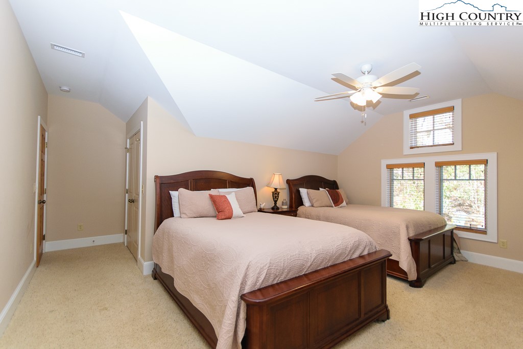 145 Rising Fawn Pass, Unit 17B Boone, NC 28607 - Photo 31 of 49 a bedroom with bed and a large window