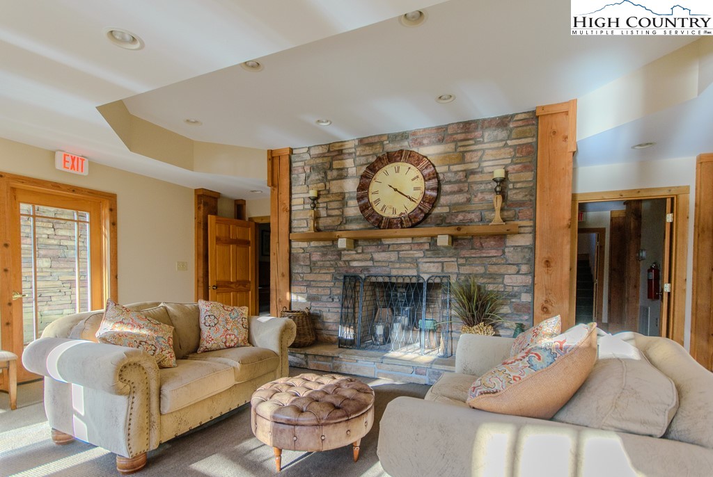 145 Rising Fawn Pass, Unit 17B Boone, NC 28607 - Photo 41 of 49 a living room with furniture a fireplace and a large window