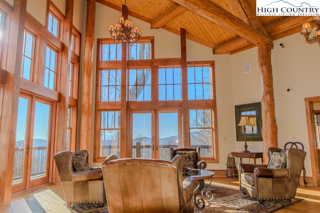145 Rising Fawn Pass, Unit 17B Boone, NC 28607 - Photo 43 of 49 a living room with furniture and floor to ceiling windows
