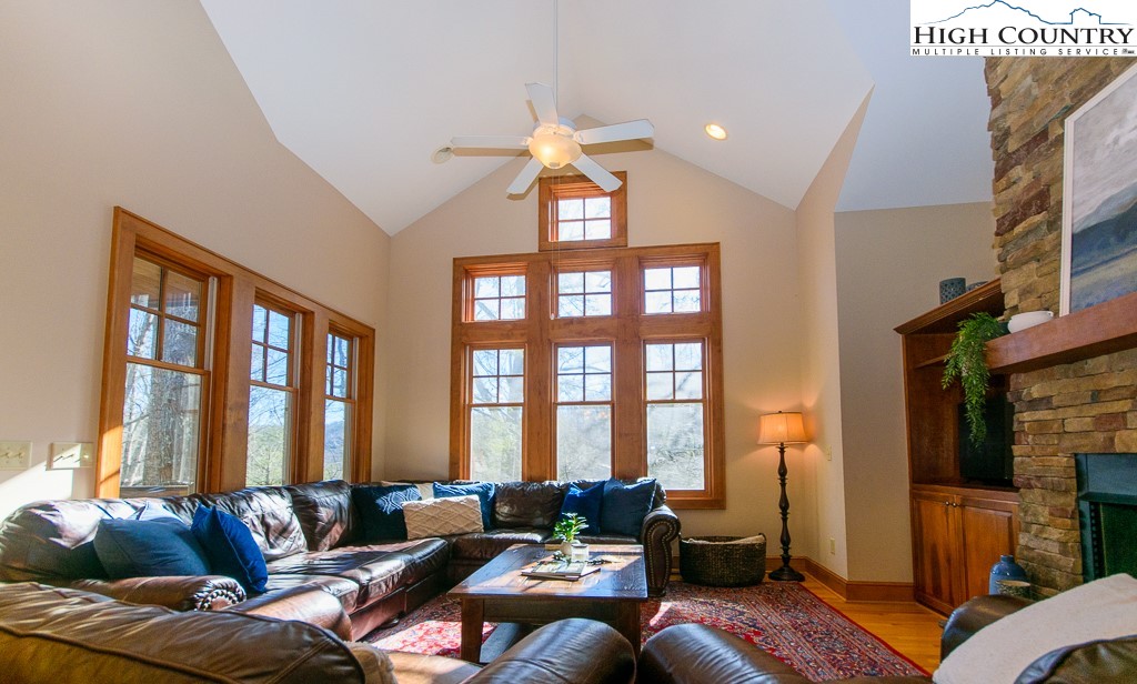 145 Rising Fawn Pass, Unit 17B Boone, NC 28607 - Photo 5 of 49 a living room with furniture and large windows