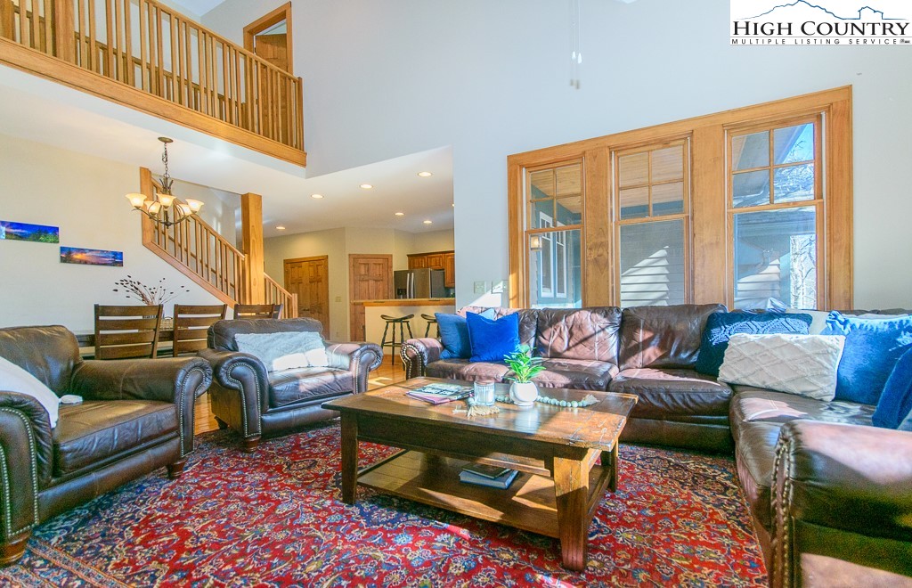 145 Rising Fawn Pass, Unit 17B Boone, NC 28607 - Photo 7 of 49 a living room with furniture a rug and a large window