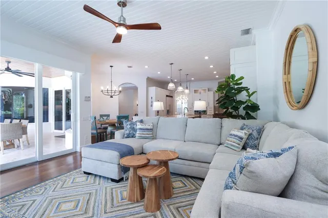 a living room with furniture and a chandelier