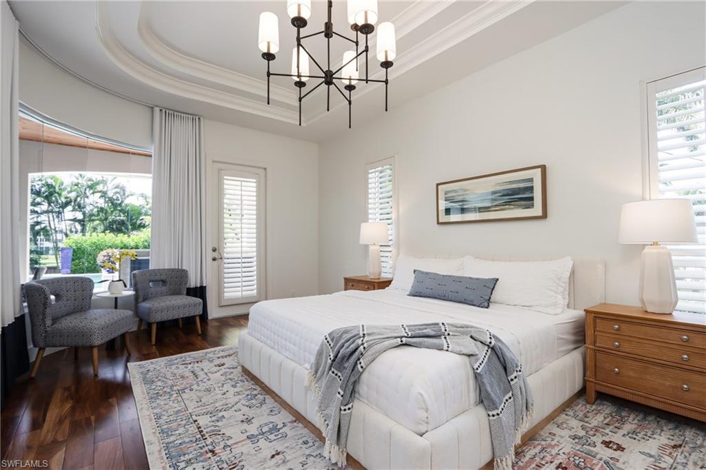 678 11th Avenue South Naples, FL 34102 - Photo 18 of 34 a bedroom with a large bed and a couch