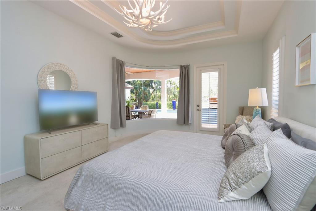 678 11th Avenue South Naples, FL 34102 - Photo 34 of 34 a spacious bedroom with a bed and a flat tv screen