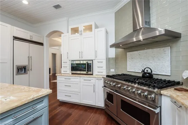 a kitchen with stainless steel appliances granite countertop a stove and a microwave