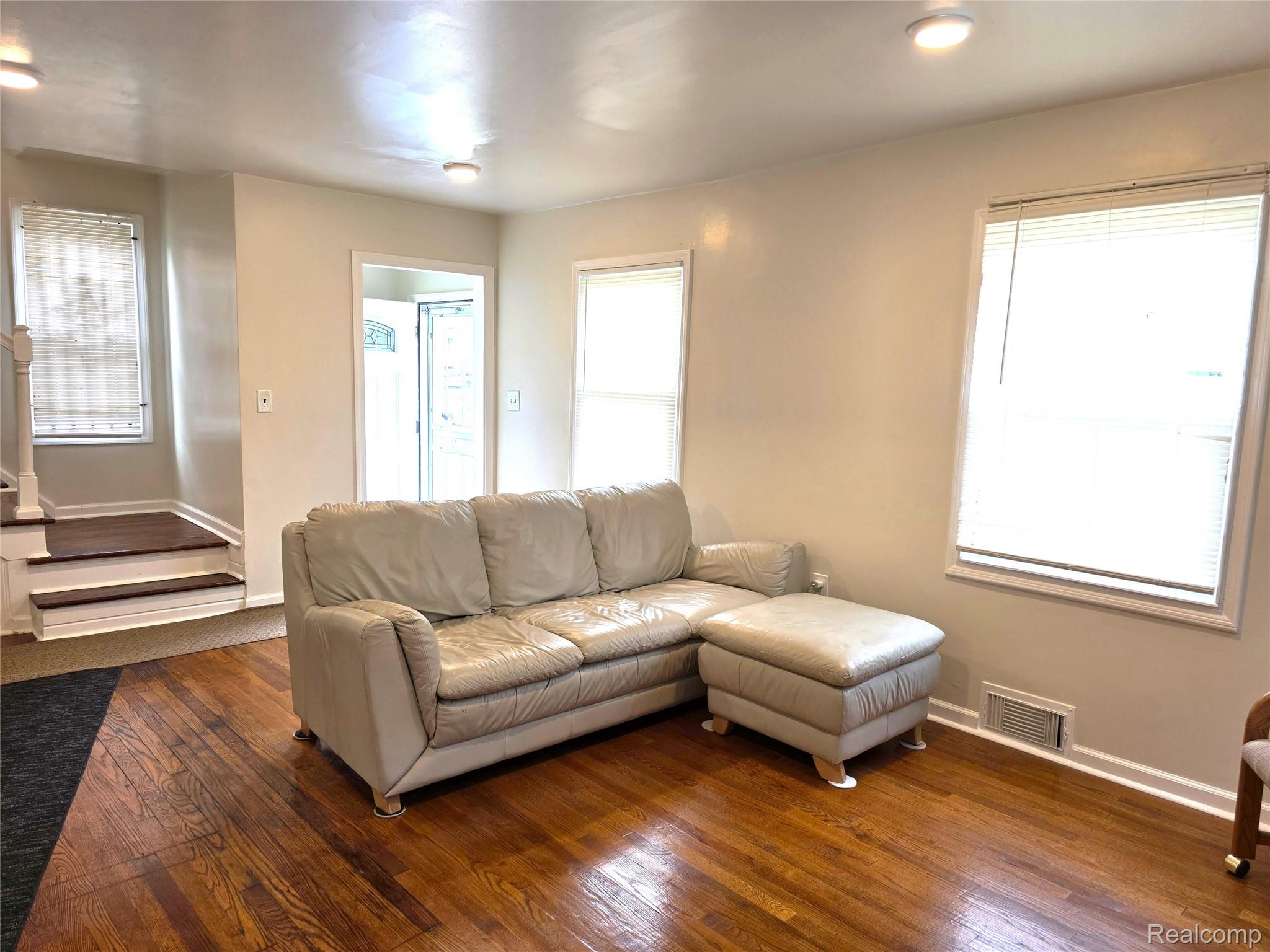 16814 Strathmoor Street Detroit, MI 48235 - Photo 5 of 31 Hardwood flooring throughout, recessed lighting, and multiple windows with blinds