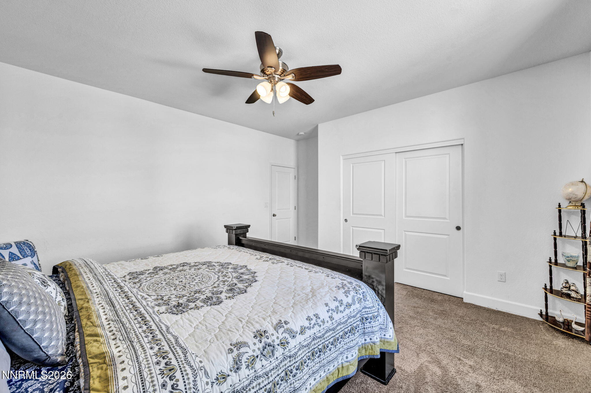 969 Estuary Circle Reno, NV 89506 - Photo 20 of 38 a bedroom with a bed and a chandelier