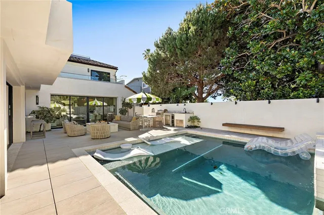 swimming pool view with a seating space