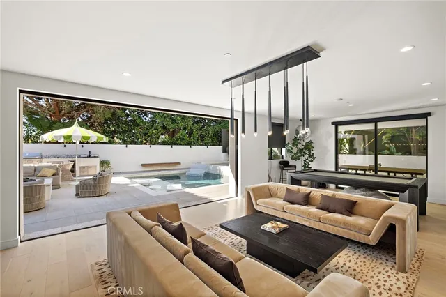 a living room with furniture large window and flat screen tv