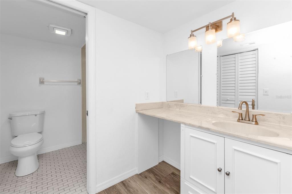 175 Kings Highway, Unit B6526 Punta Gorda, FL 33983 - Photo 14 of 44 a bathroom with a granite countertop sink a toilet and a mirror